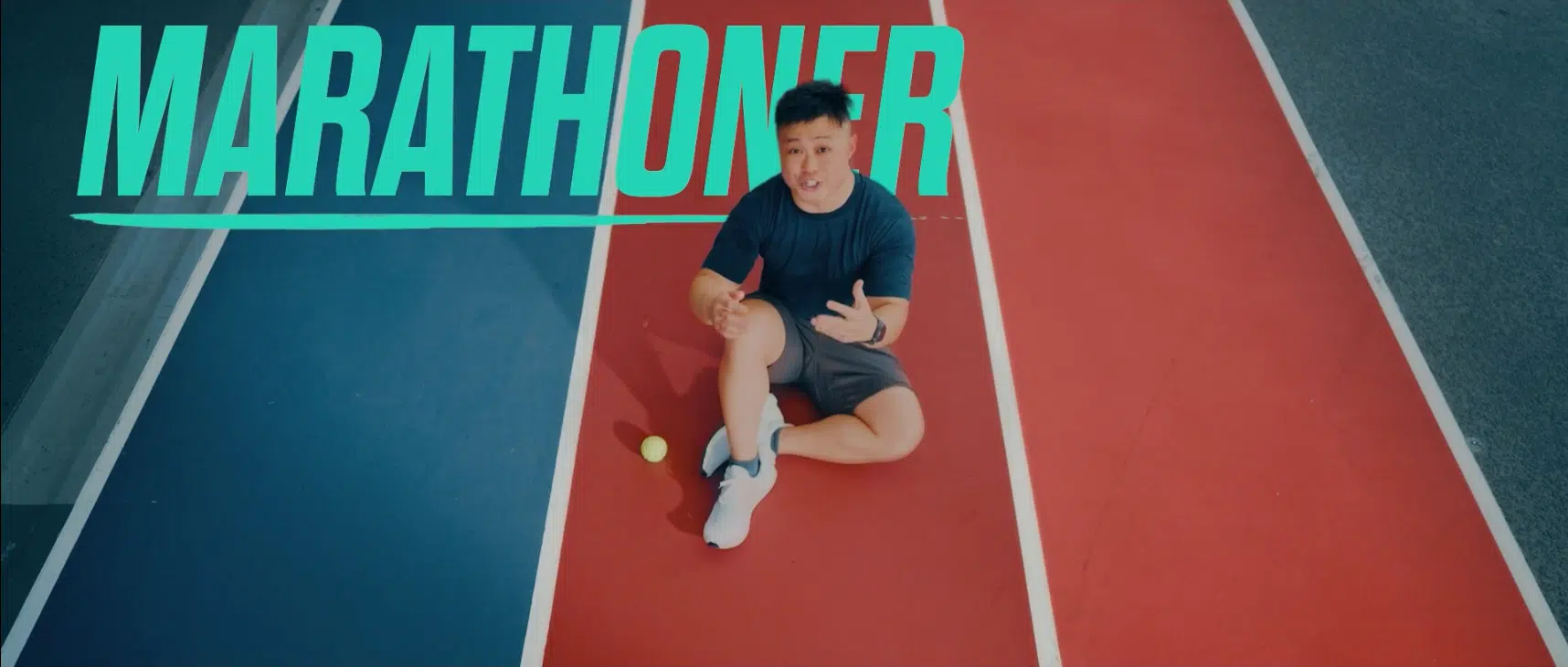 a man sitting on a track explaining IP sports tech